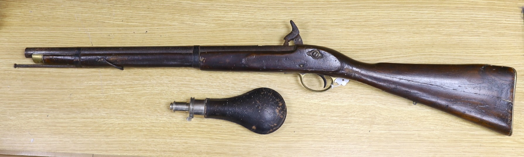 A 19th century percussion cap carbine musket with name stamped to lock plate and a shot flask, musket 94cms long